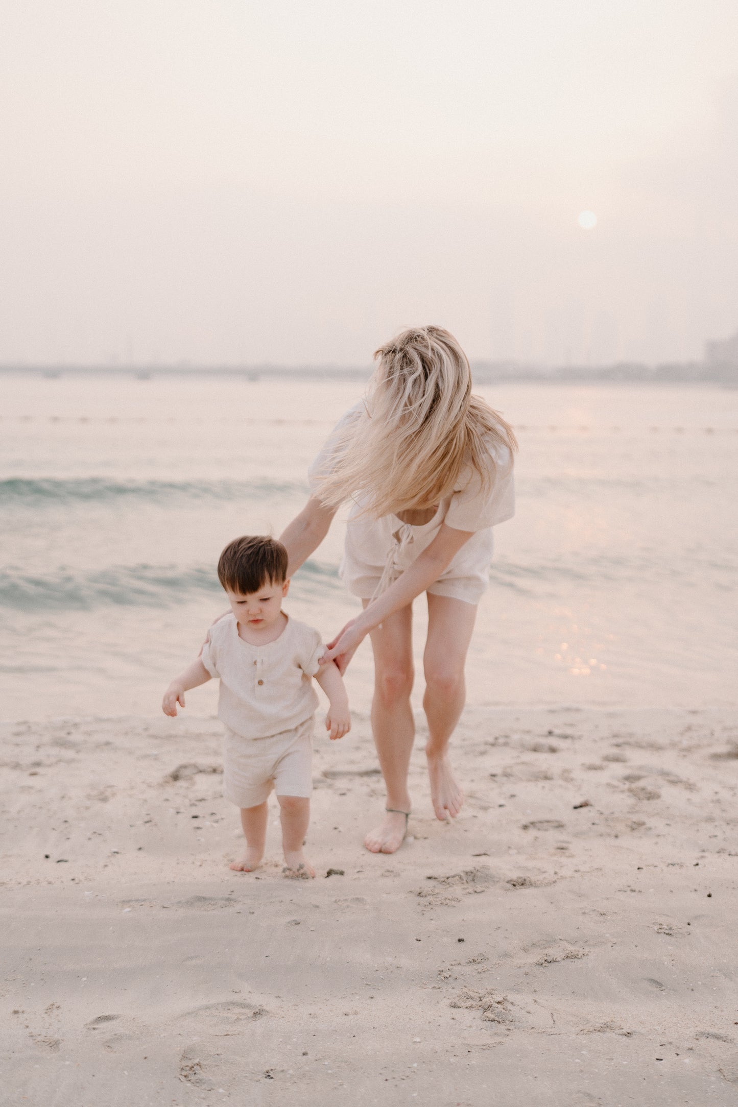 Toddler on Dubai Beach in Matching Mummy and Me Linen Beige Co-ord Outfits