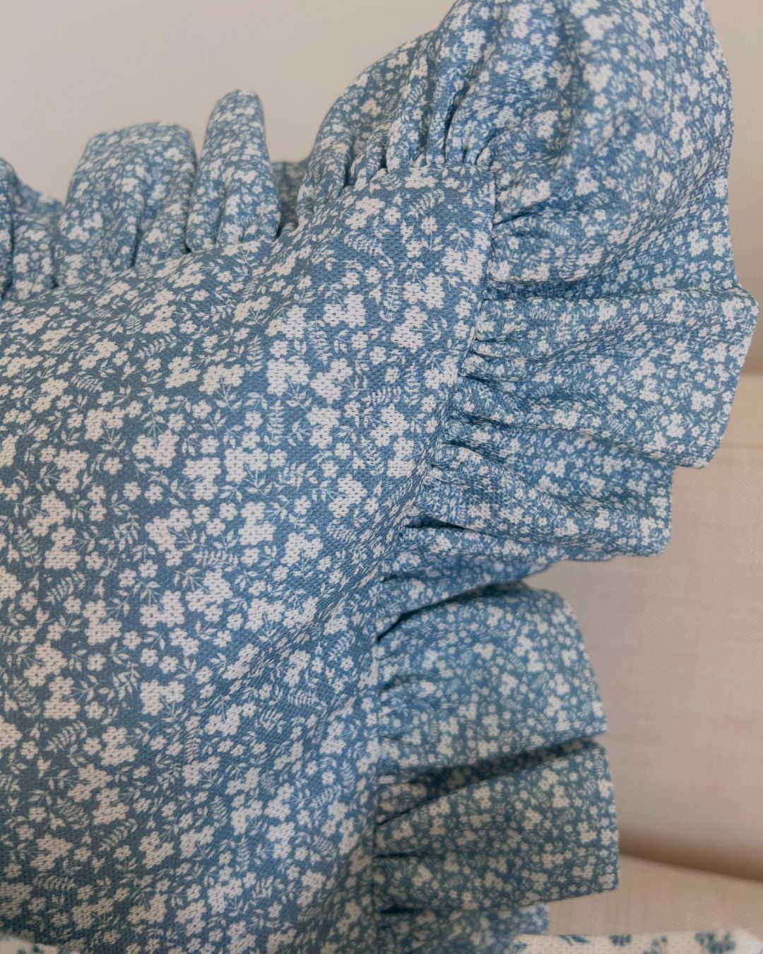 Vintage countryside-inspired blue cushion with frill edge