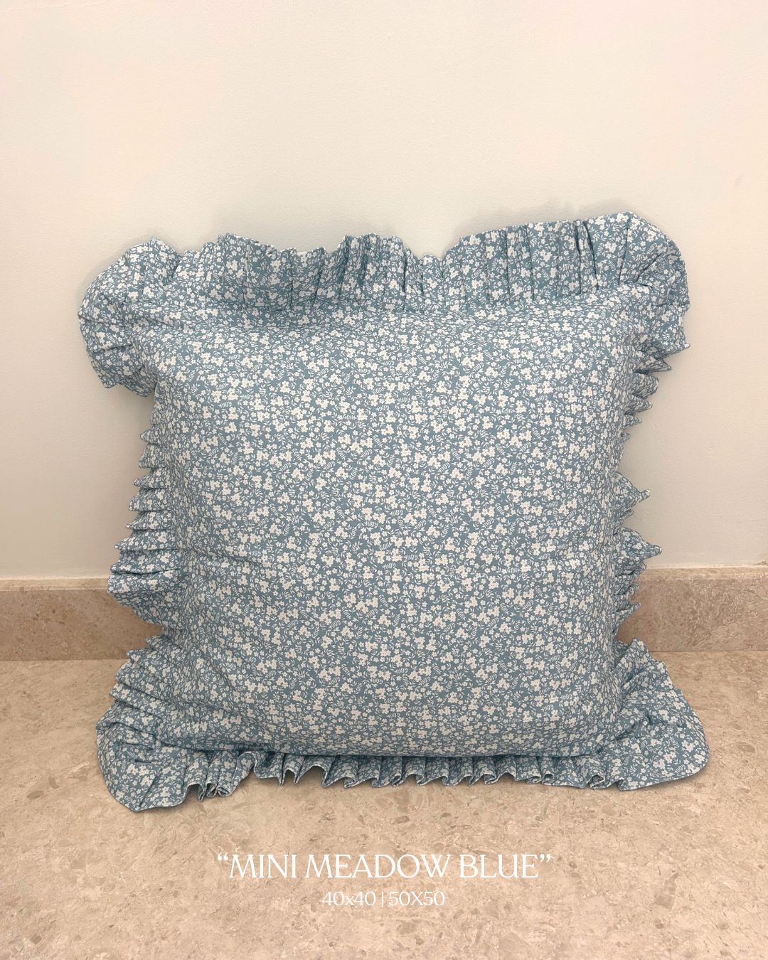 Vintage countryside-inspired blue cushion with frill edge